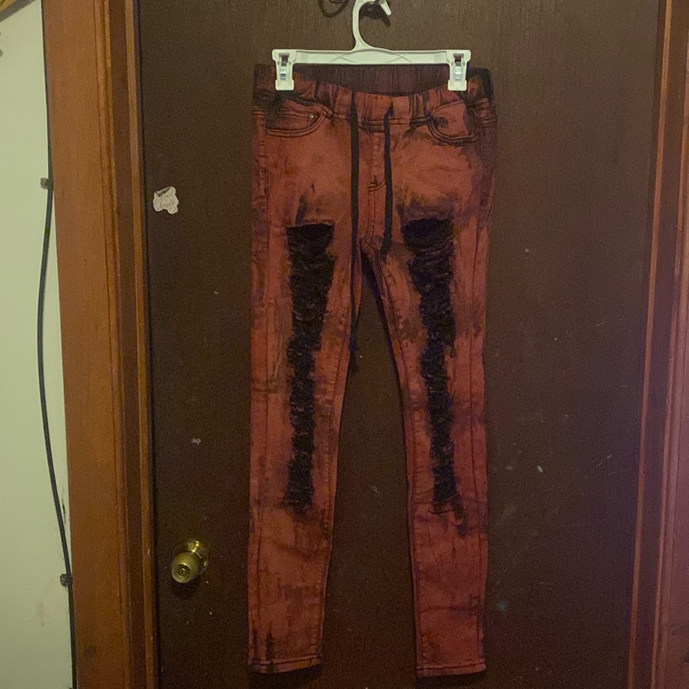 Red and black dyed jeans. Elastic waist. Stretch throughout.